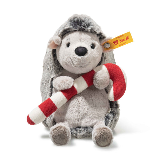 Front view of Steiff Cosy Christmas Hedgy Hedgehog plush holding a red and white candy cane