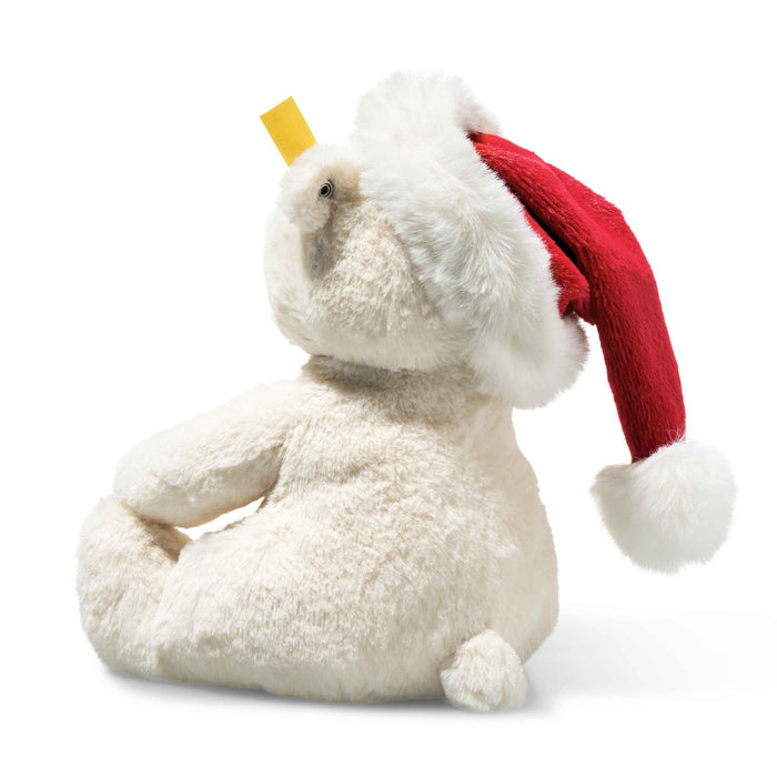 Rear angled view of Steiff Rico polar bear with fluffy Santa hat and tiny tail