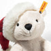 Close-up of Rico polar bear showing soft white fur, black nose and Steiff ear tag beneath the hat brim
