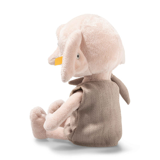 Rear angled view of Steiff Dobby plush in brown tunic with oversized ears visible.
