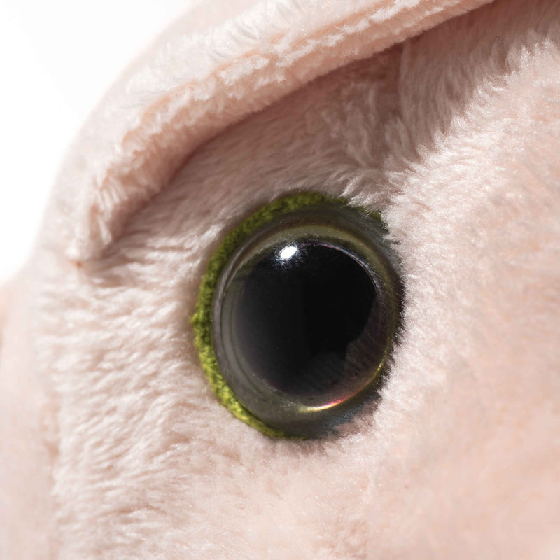 Extreme close-up of Steiff Dobby’s green-ringed eye and soft plush texture.