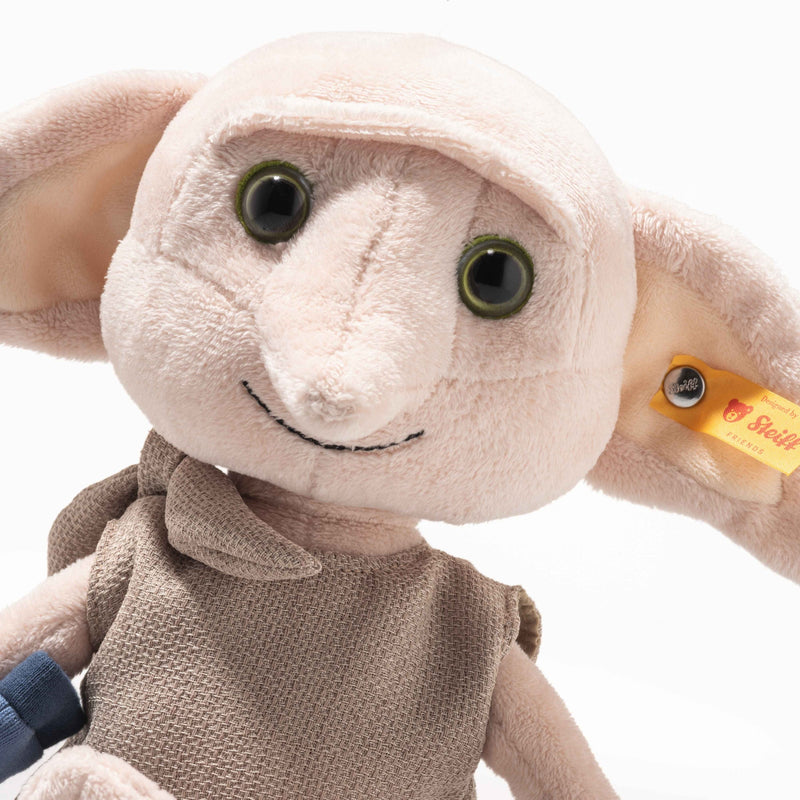 Head and shoulders view of Steiff Dobby plush showing smile, big ears and Steiff ear tag.