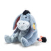 Angled view of Steiff Eeyore plush, blue-grey with pink bow tail and Button in Ear – Steiff teddy bears