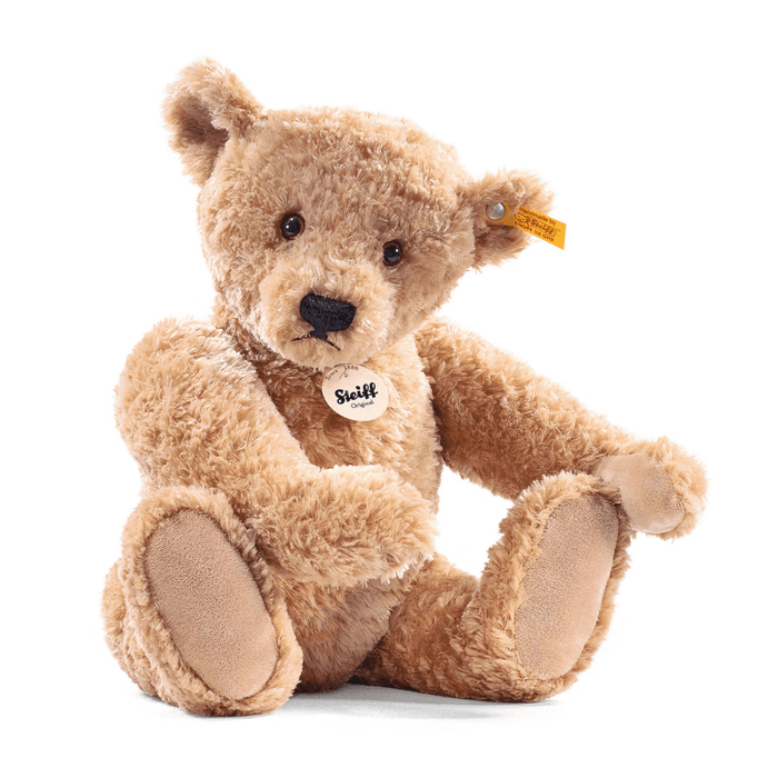 Steiff Elmar Teddy Bear in soft beige plush sitting forward with the classic yellow and red ear tag on a white background