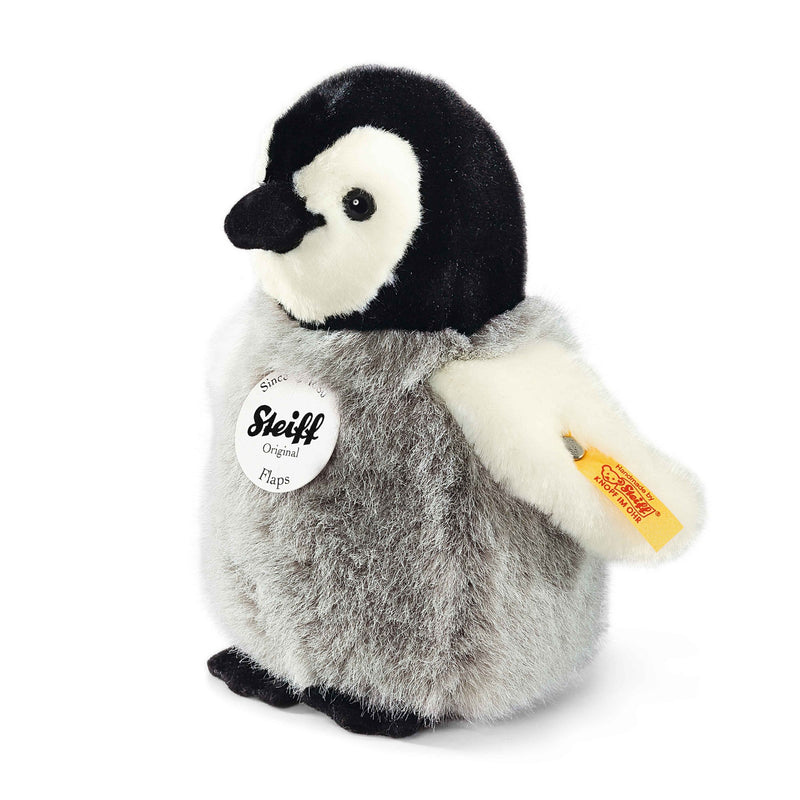 Steiff Flaps penguin plush toy, grey body, cream wings, classic yellow-red ear tag – Steiff teddy bears.