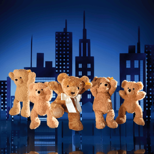 Steiff Fynn Teddy bear in beige plush with other teddy bears against a blue city skyline background
