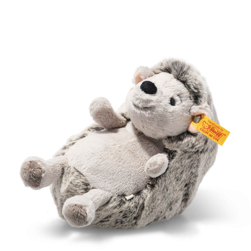 Steiff Hedgy Hedgehog plush lying on its back with soft spines and Button in Ear – Steiff teddy bears