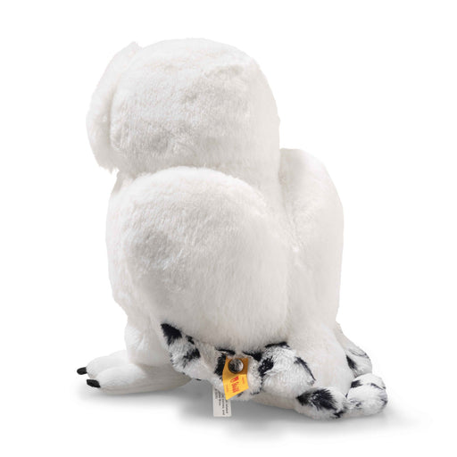 Back view of Steiff Hedwig snowy owl plush showing wings, speckled tail and yellow ear tag