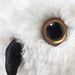 Close-up of Steiff Hedwig snowy owl plush golden eye and black beak
