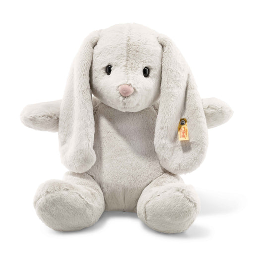 Steiff Hoppie rabbit plush, soft grey with floppy ears and pink nose, front sitting view with yellow ear tag – Steiff teddy bears.