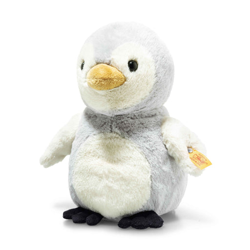 Angled view of Steiff Lio Penguin plush, grey and cream chick with yellow beak and Button in Ear – Steiff teddy bears