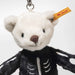 Close-up of Mr Bones keyring with soft white face, brown nose and Steiff ear tag