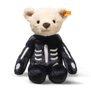 Full-length seated front view of Steiff Mr Bones teddy in skeleton outfit