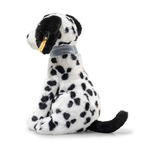 Side view of Steiff Oskar Dalmatian seated, spotty coat and curved tail