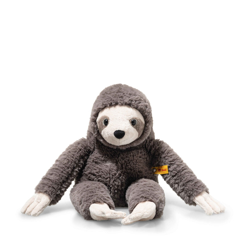 Steiff Sanny Sloth plush toy sitting with long arms, grey fluffy fur and yellow ear tag, front view.