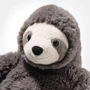Close-up of Steiff Sanny Sloth plush face with soft cream muzzle and big eyes framed by grey fur.