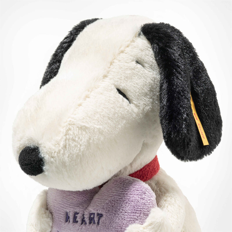 Side profile of Snoopy showing soft black ears, red collar and Steiff ear tag