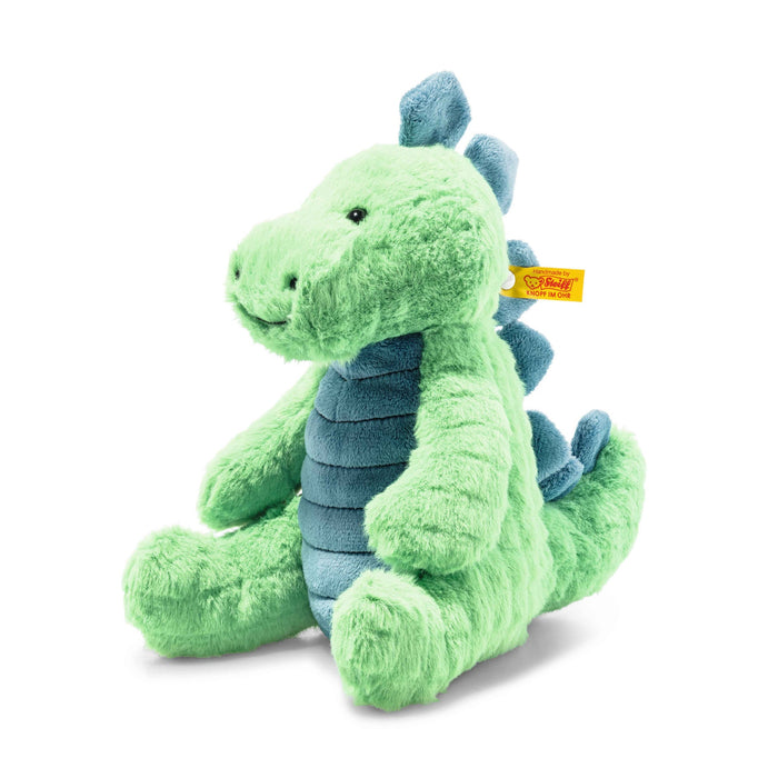 Angled view of Steiff Spott Stegosaurus plush, bright green with blue plates and Button in Ear – Steiff teddy bears
