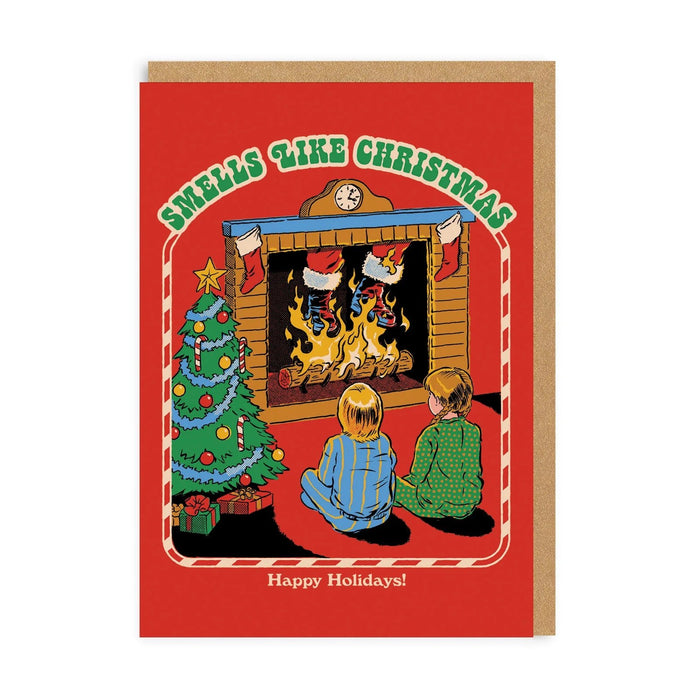Red retro Christmas card with two kids by a fireplace and tree; arched text “Smells Like Christmas”; A6, blank inside, brown kraft envelope by Steven Rhodes