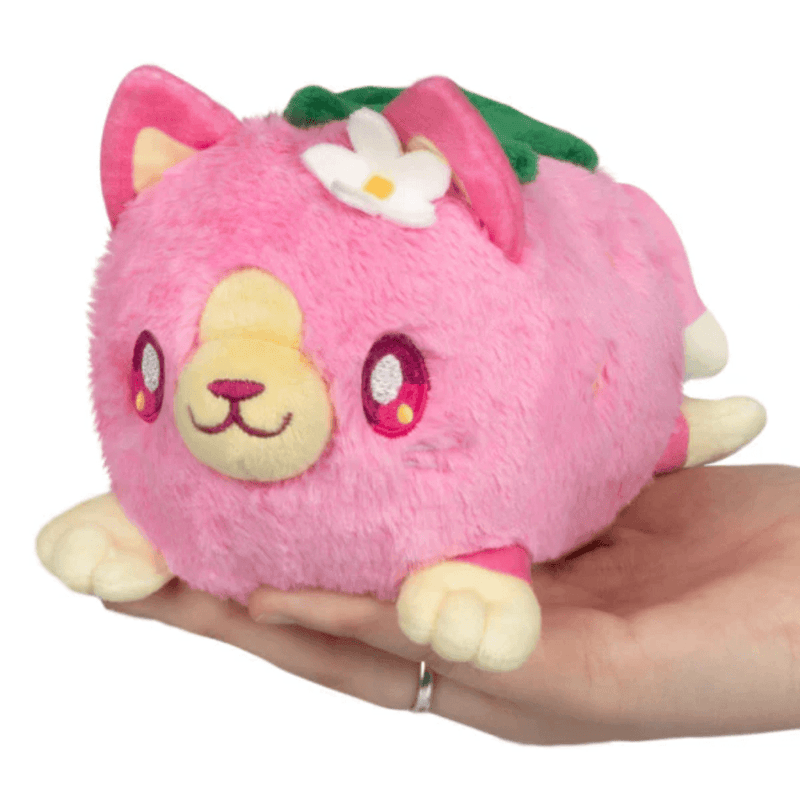 Front view of Squishable Alter Egos Strawberry Kitty Plush with pink fur, flower detail and strawberry-inspired design