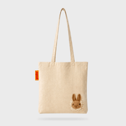 Full front view of the SUCK UK Peeky Bunny natural cotton tote bag with cream canvas, shoulder straps and plush brown rabbit.
