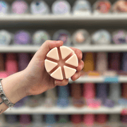 Sugared Blossom wax melt segments held in hand with colourful wax melt display in the background