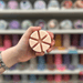 Sugared Blossom wax melt segments held in hand with colourful wax melt display in the background