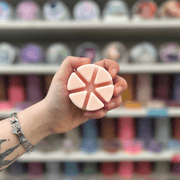 Summer Scoop wax melt segments held in hand with colourful wax melt display in the background