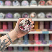 Summer Scoop wax melt pot held in hand with colourful wax melt display in the background