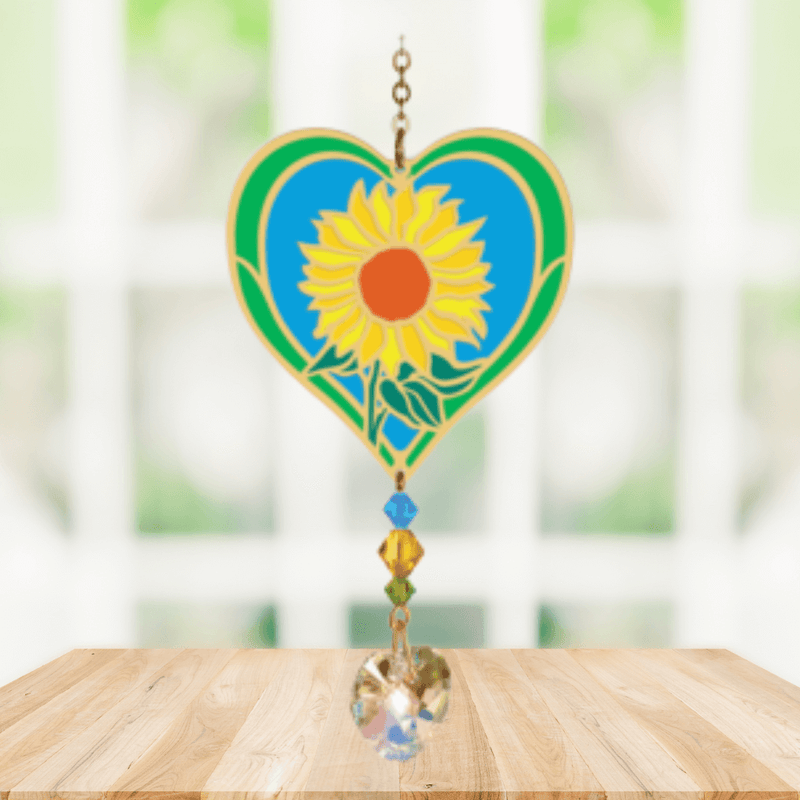 Heart-shaped Sunflower Crystal Suncatcher with bright yellow sunflower motif and faceted prism heart catching sunlight in a window


