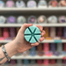 Sweet Nothings wax melt segments held in hand with colourful wax melt display in the background