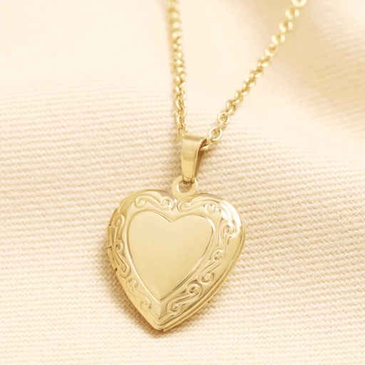 Gold stainless steel heart locket necklace with swirl detailing, shown closed on a fine gold chain.