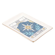Angled view of gold-edged Tarot The Star ceramic dish on white background.
