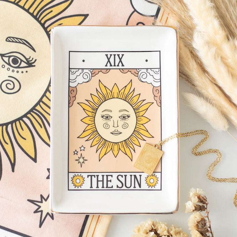 Tarot The Sun ceramic trinket dish styled with necklace and pampas grass.
