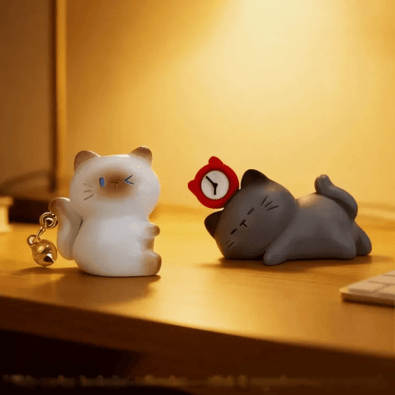 Bell Kitty and Sleepy Kitty ThingsWoo cat figures displayed together under warm lighting