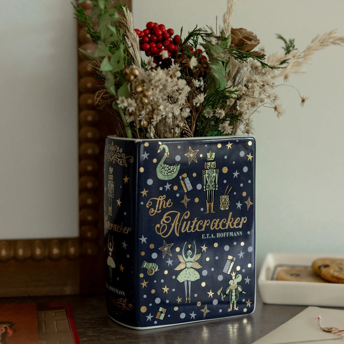 Side angle of The Nutcracker ceramic book-shaped vase showing artwork and sculpted pages