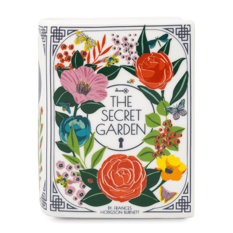 Front cover of The Secret Garden book shaped candle with colourful floral illustration and title.