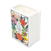 The Secret Garden book shaped ceramic candle, unlit, angled view showing floral cover and book spine.