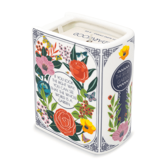 The Secret Garden book candle showing floral quote panel and spine key motif from an angled top view.