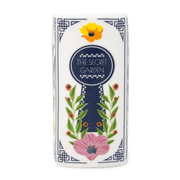 Close-up of The Secret Garden candle spine with keyhole artwork and floral details.