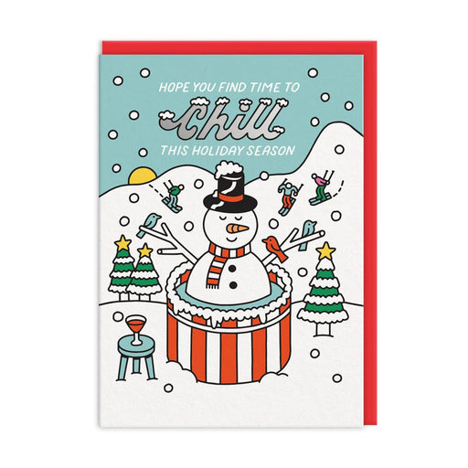 A6 Christmas card by The Social Type featuring a snowman chilling in a red-and-white hot tub with skiers and trees; silver-foil text reads “Hope you find time to chill this holiday season”; blank inside with brown kraft envelope