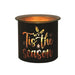 Black and gold Tis the Season tealight wax melter glowing with warm light