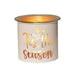 White and gold Tis the Season tealight wax melter glowing with warm light