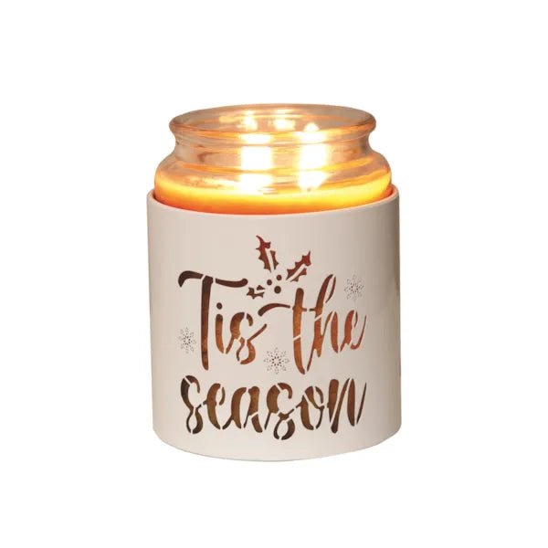 White Tis the Season sleeve used as a candle jar holder with lit jar inside