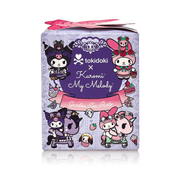 Tokidoki collectible Kuromi & Bloom figure with lavender-rose crown, posed beside Garden Tea Party blind-box packaging.

