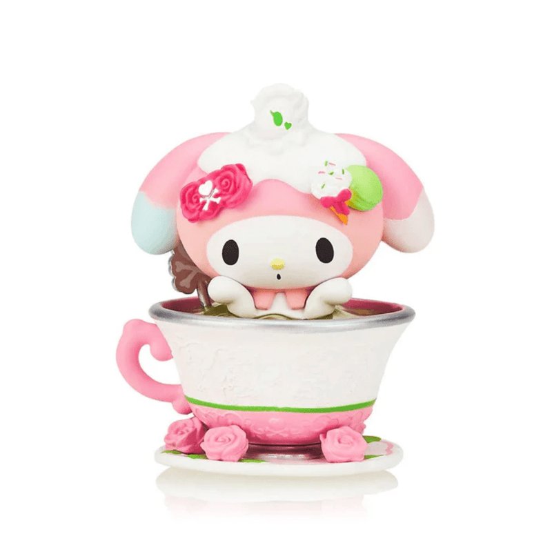 Tokidoki collectible My Melody Matcha figure peeking from white lace-textured teacup, topped with cream and pink roses.
