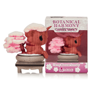 Front view of Tokidoki Unicorno Cherry Blossom Serenity collectible figure in bonsai pot, displayed beside Botanical Harmony retail packaging.

