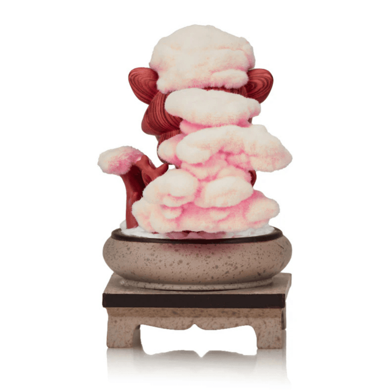 Tokidoki Cherry Blossom Serenity collectible shown from behind, revealing fluffy pink sakura blooms and wood-grain Unicorno trunk.

