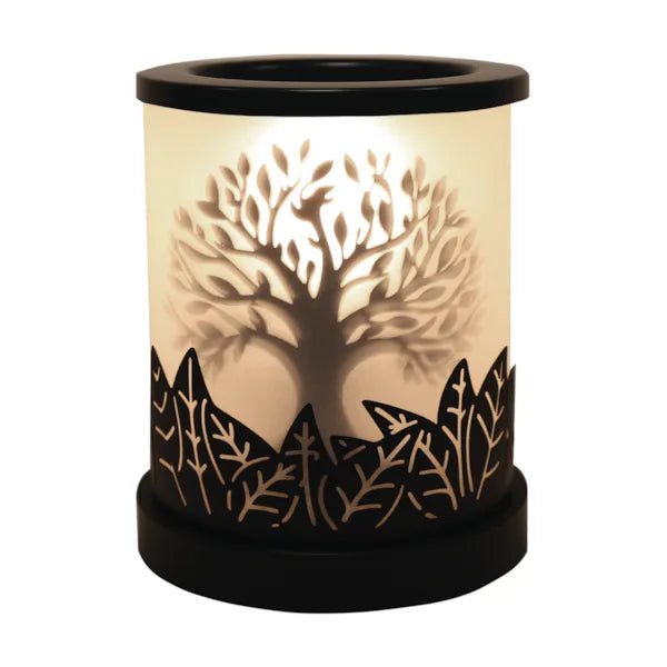 Tree of Life electric wax melt burner glowing warmly with a black cut-out silhouette design around the base.