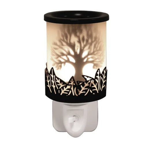 Black Tree of Life plug in wax melt burner glowing warmly with a cut-out silhouette design and on/off switch on the plug base.